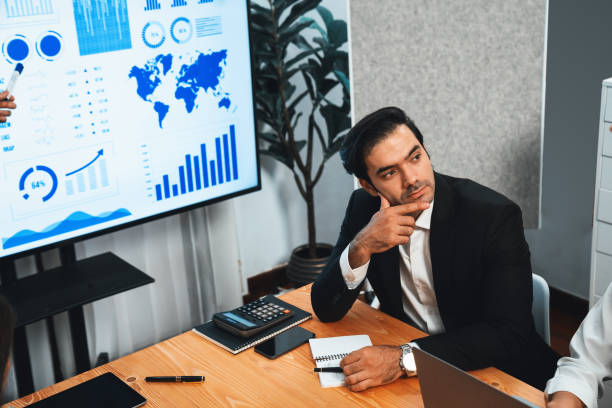 istock Group of business analyst team analyzing financial data report. Habiliment 2182978034
