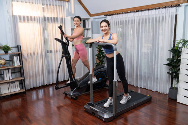 istock Energetic and strong athletic asian woman running on machine. Vigorous 2182978112