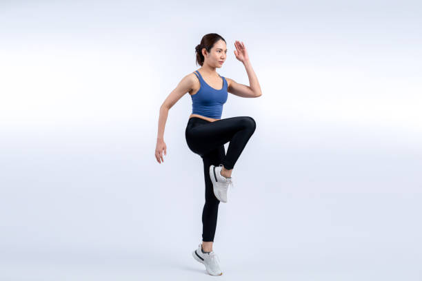 istock Side view young athletic asian woman on running posture. Vigorous 2182978556