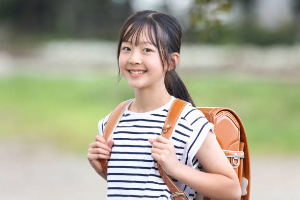 istock A girl carrying a school bag 2182978681