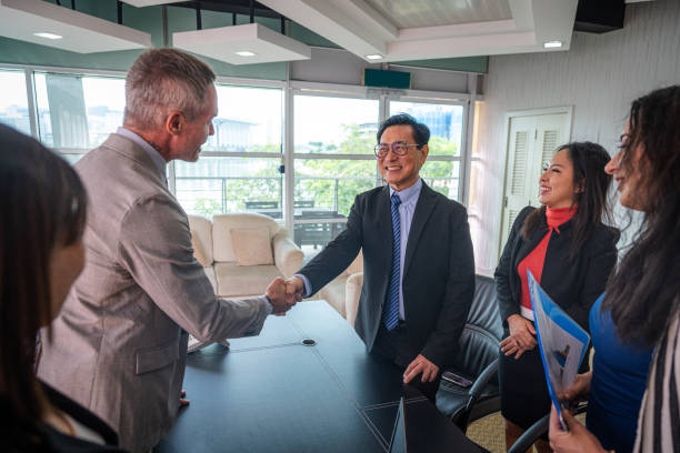 istock Forging Partnerships: Businesspeople Shake Hands in a Modern Office Setting 2182978883