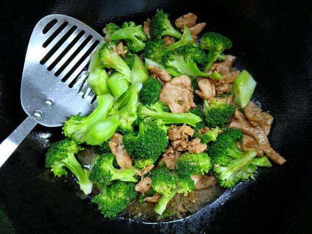 Stir fried Broccoli with pork in cooking pan - food preparation.