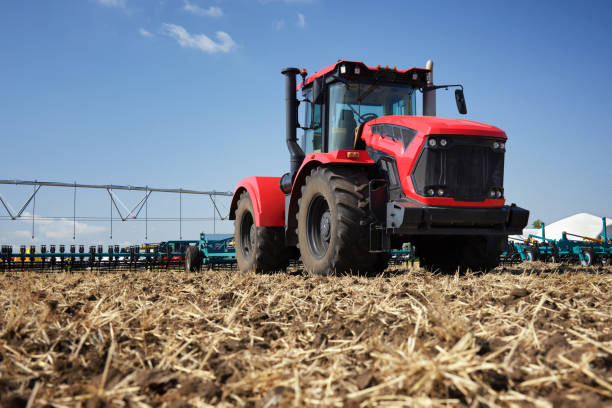 istock A large tractor work with a plow in a field. Start tillage after harvest. 2182985114