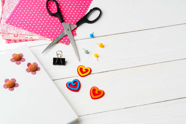 istock Crafting a colorful workspace with decorations, stationery, and artistic tools on a clean wooden surface 2182990820