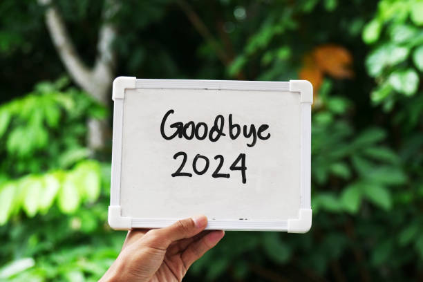 istock a hand holding a whiteboard with text Goodbye 2024. 2182992315