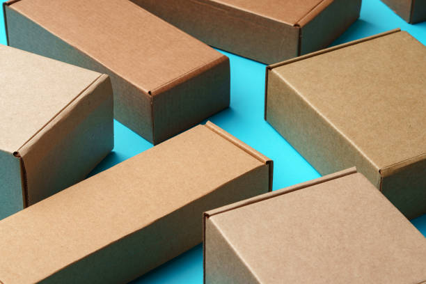 A collection of cardboard boxes arranged on a bright blue surface