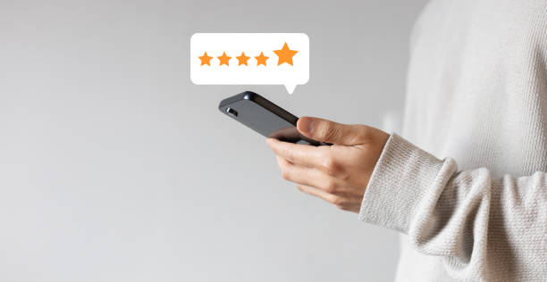 istock close up on customer man hand check on gold five star rating feedback icon and press level best rank  for give score point to review the service business concept 2182993282
