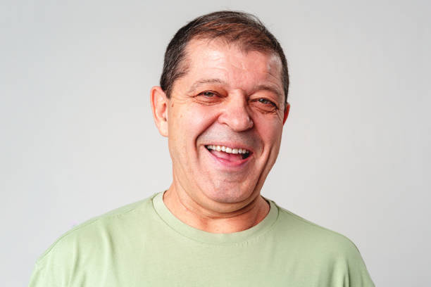 istock Smiling older man with a warm expression against a neutral background, showcasing happiness and joy 2182995143