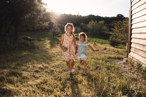 Beautiful sisters enjoying nature. It’s sunset.