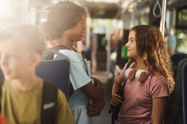 istock Schoolgirl talking while going to school in a bus. 2182996826
