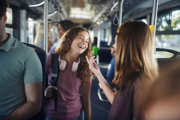 istock Happy students talking while traveling to school in a bus. 2182997134