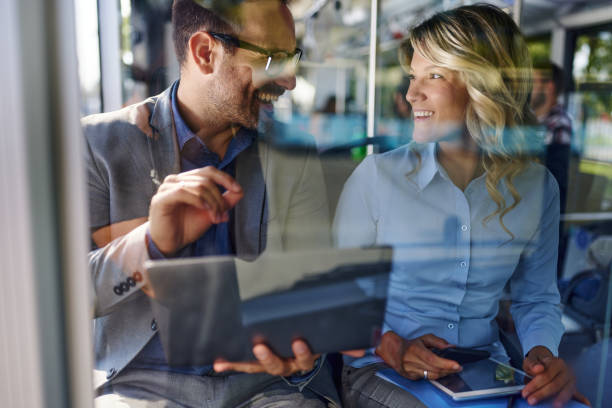 istock Happy business colleagues talking in a public transportation. 2182997284