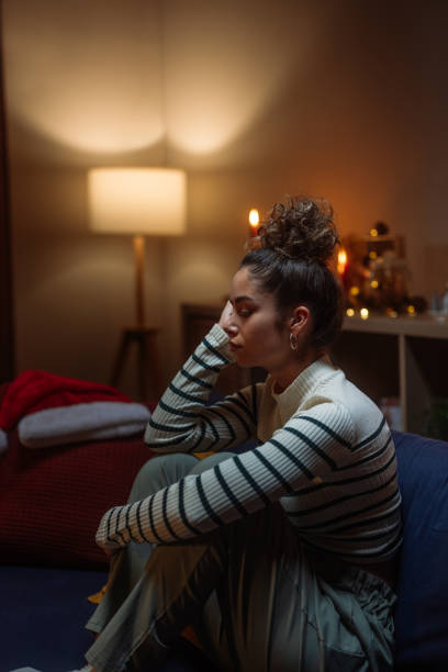 istock Sad woman sitting on sofa during christmas holidays feeling lonely 2182999006