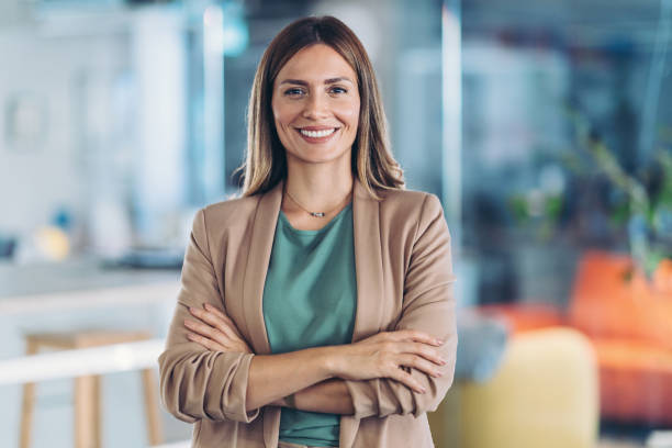 istock Smiling beautiful woman standing in the office 2182999893