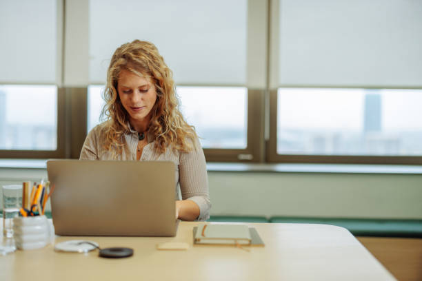 istock Businesswoman happily working in a modern office 2183004075