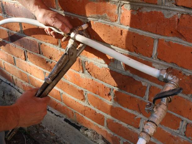 istock repairing a plumbing system with an adjustable wrench 2183009253