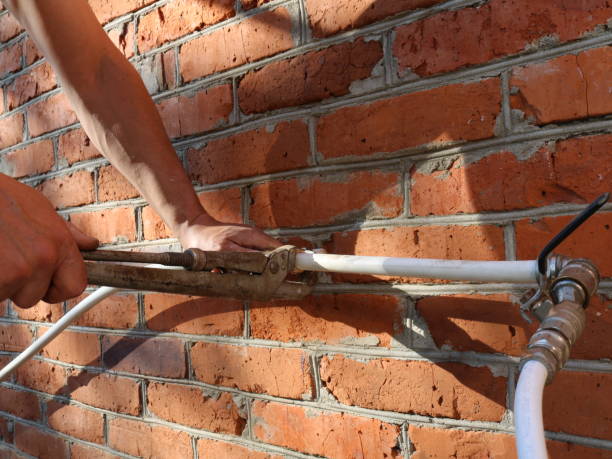 istock working with a gas wrench in installing a plastic pipe 2183009264