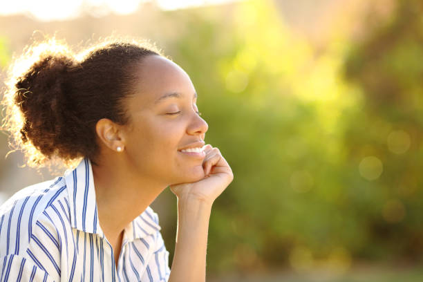 istock Happy black woman resting in a garden 2183009461