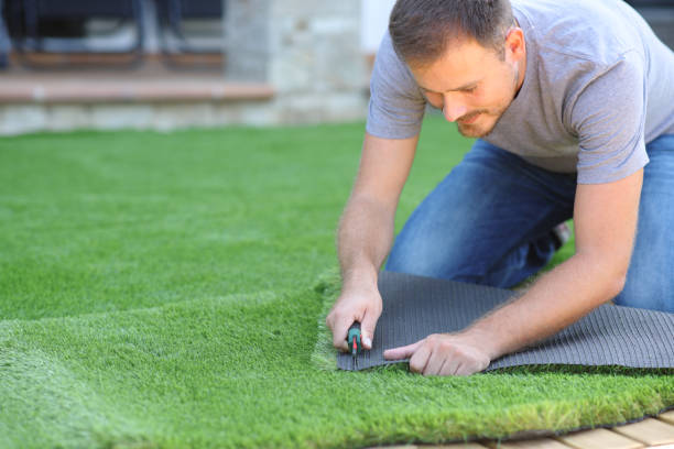 istock Man installing and cutting artifial turf 2183009719