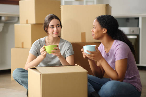 istock Two interracial roommates planning house move 2183009810
