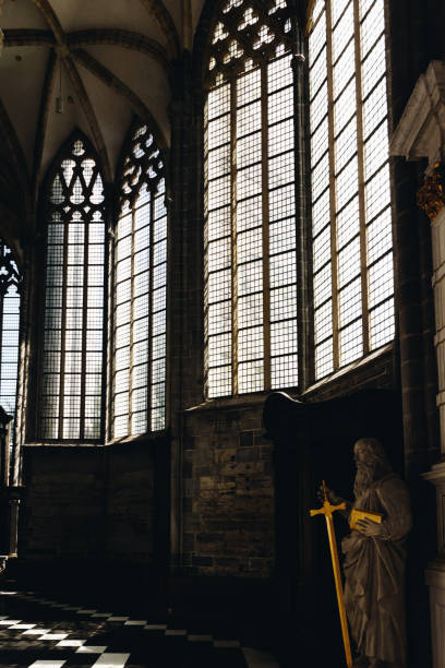 Sun shining through tall windows in an ancient cathedral
