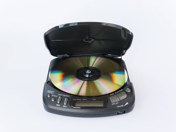 istock Front closeup view of CD player with open lid and golden CD inside isolated on white background 2183010168