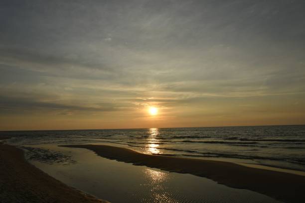 istock Serene beach sunset with golden sky. 2183011253