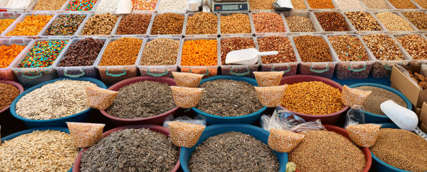Vibrant display of assorted nuts and dried fruits at a bustling market in Turkey during the day