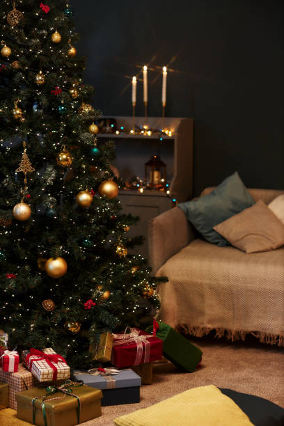 istock Dim Home Interior with Decorated Christmas Tree Gold Details 2183012706
