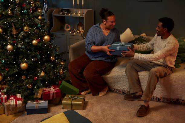 istock Couple Exchanging Gifts on Christmas 2183012727