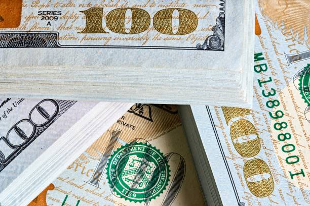 New US Dollar USD 2009 series bill bundles background for design. Many bundle of US 100 dollars bank notes.