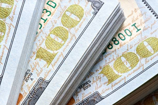 New US Dollar USD 2009 series bill bundles background for design. Many bundle of US 100 dollars bank notes.