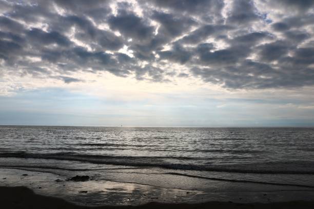 istock Cloudy sky over calm sea at dawn 2183013650