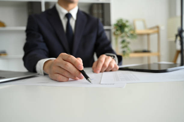 istock Professional businessperson reviewing contract documents at work desk 2183016524