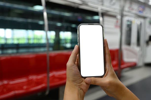 istock Hands holding a smartphone with blank screen in city subway 2183016928