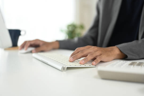 istock Close up of businessman typing on wireless keyboard at modern workspace 2183017066