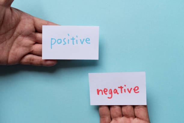 istock People who have negative and positive cards 2183017107