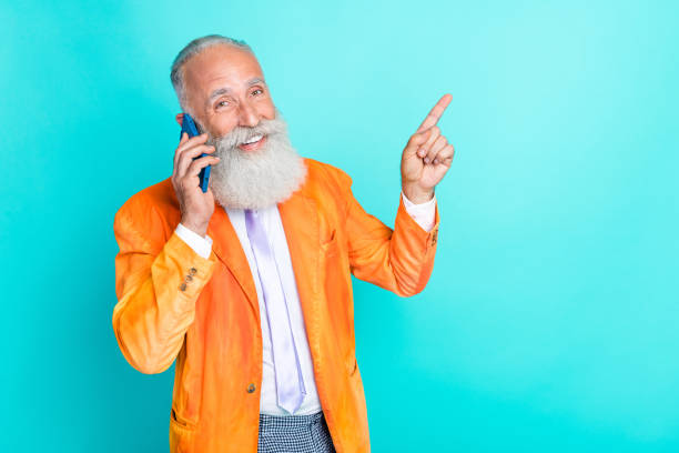 istock Portrait of handsome grandfather communicate telephone indicate finger empty space isolated on teal color background 2183017191