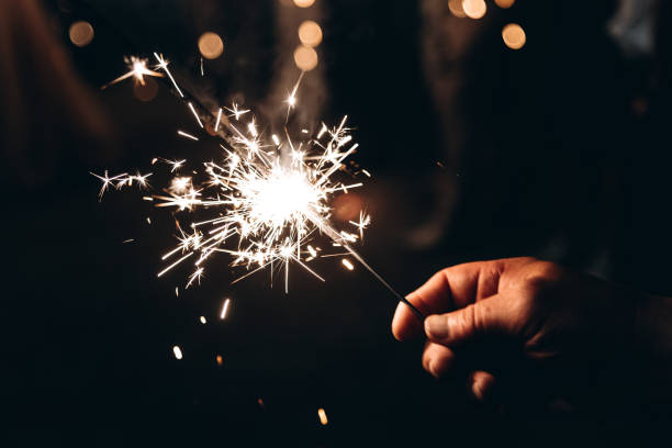 istock sparkling sparkler in man hand 2183017458