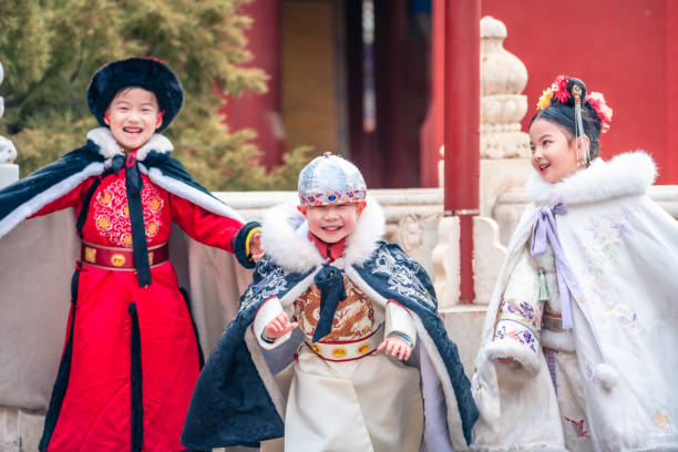 Three kids in ancient costumes chasing each other