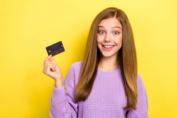 istock Photo of astonished lady wear trendy violet pullover hold plastic card use easy functions empty space isolated on yellow color background 2183020163