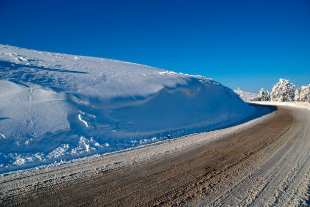 icy mountain road against the sky