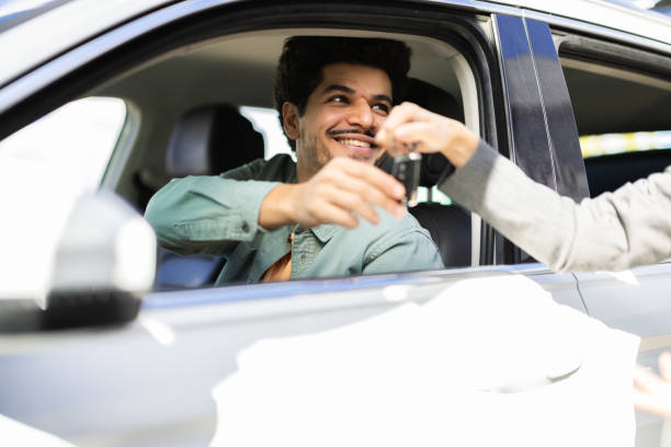 istock Middle Eastern man taking over the key of his just bought car 2183023027