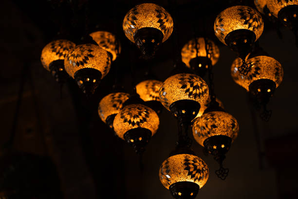 Lamps and lanterns in an authentic store, featuring decorative art, bright colors, and intricate glass designs. Ideal for themes of cultural tourism, interior decor, and vintage-inspired souvenirs