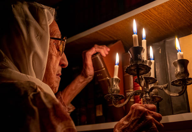 Elderly Woman Illuminated by Candlelight in Library