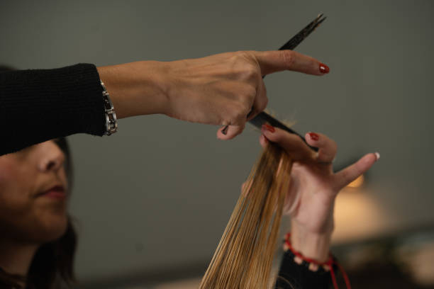 istock hairdresser's hands with scissors and comb 2183030311