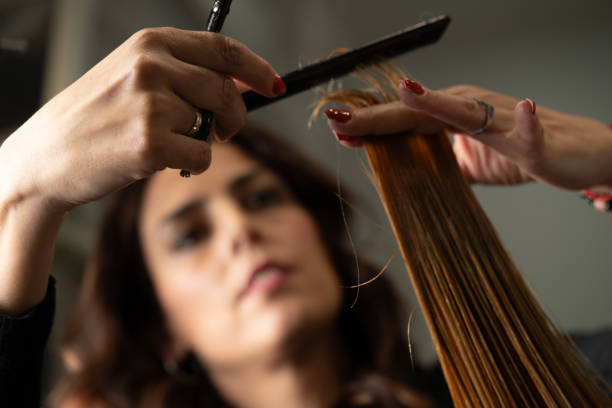istock hairdresser working in concentration with comb and scissors 2183030643
