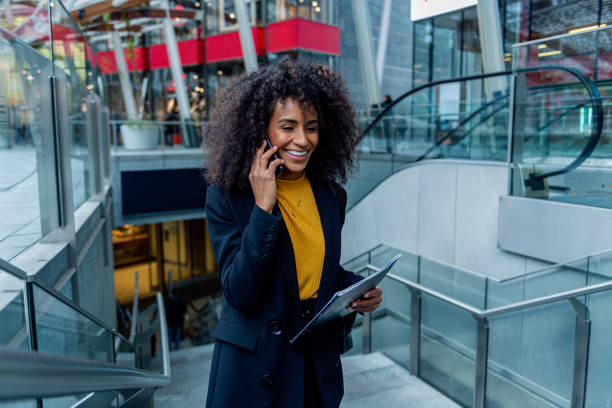 istock Confident young businesswoman on the go using her smartphone 2183031768
