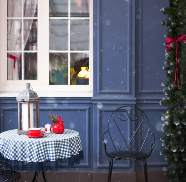 Outdoor bench with presents. A wreath on a window
