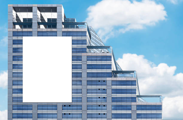 istock Mock up white vertical large LED display billboard on tower building. Clipping path for mockup 2183036959